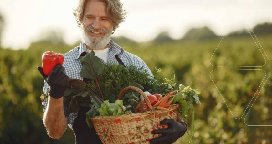 Tarlasında hasat yapan bir çiftçi, EDDHA şelatlı demir ile yetiştirdiği yüksek kaliteli kırmızı biberi inceliyor. Sepetinde verimli bir hasat görülüyor. Orto-Orto izomerinin farkıyla demir eksikliği giderilmiş sağlıklı sebzeler.